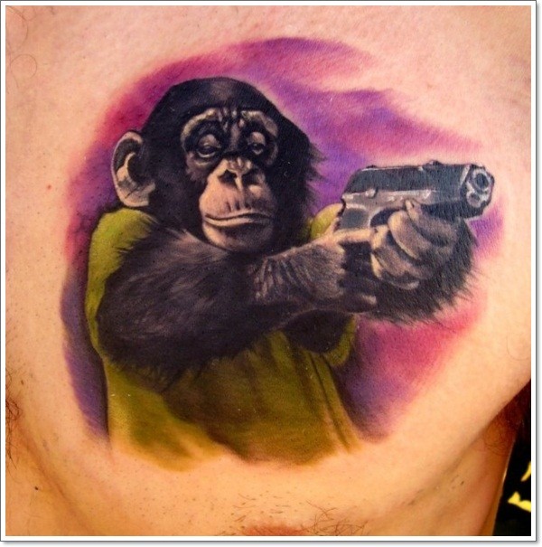 Colorful Chimpanzee With Gun In Hands Tattoo On Chest