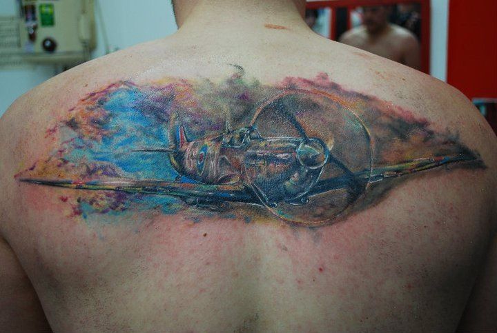 Colorful Spitfire Tattoo On Upper Back For Men