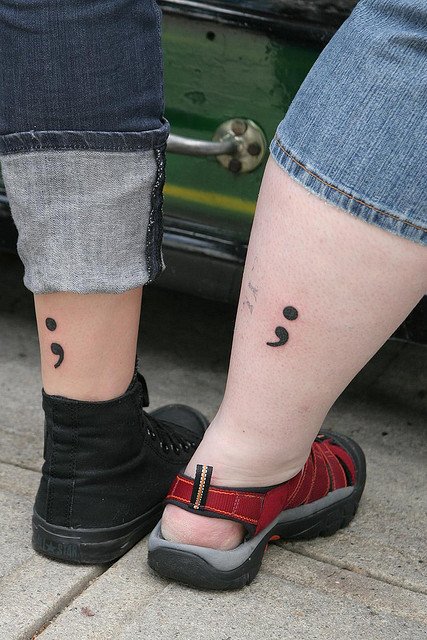 Couple With Semicolon Tattoos On Legs