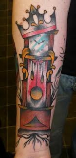 Crowned Grandfather Clock Tattoo On Right Forearm