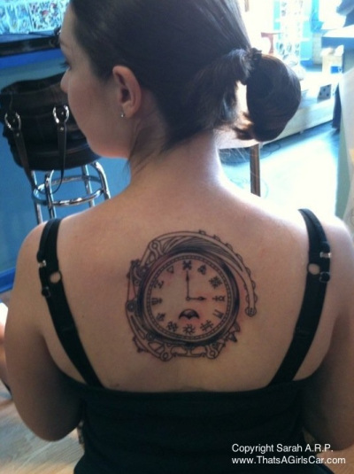 Cute Clock In Grey Ink Tattoo On Upper Back For Girls by Sarah ARP