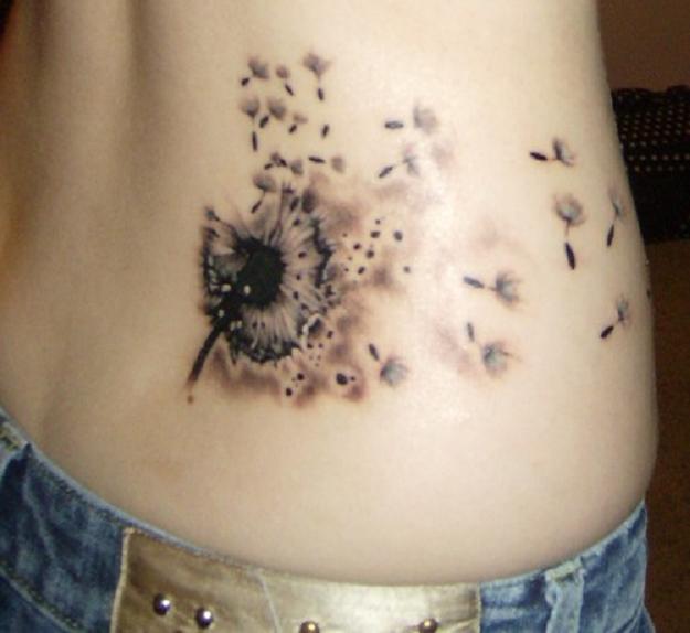 Dandelion Blowing From Puff In Amazing Ink Tattoo On Lower Back