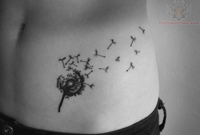 Dandelion Blowing From Puff In Beautiful Black Shape Tattoo On Hip