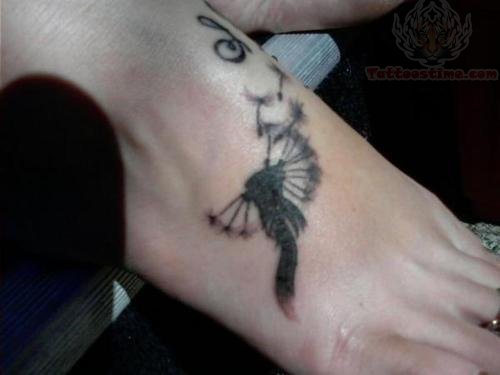 Dandelion Blowing From Puff In Black Color Tattoo On Foot