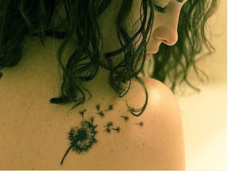 Dandelion Blowing From Puff In Black Ink Tattoo On Shoulder