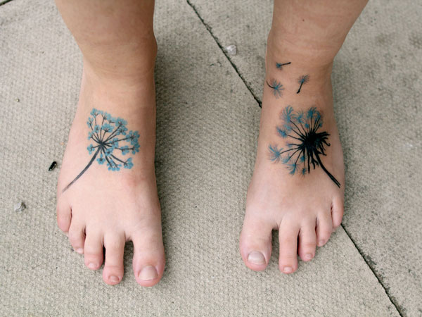 Dandelion Blowing From Puff In Blue And Black Ink Tattoo On Foot
