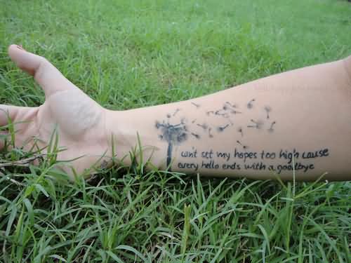 Dandelion Blowing From Puff In Dark Green Ink With Quote On Wrist