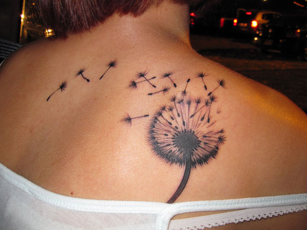 Dandelion Blowing From Puff In Light Brown And Black Ink On Left Upper Back For Girl