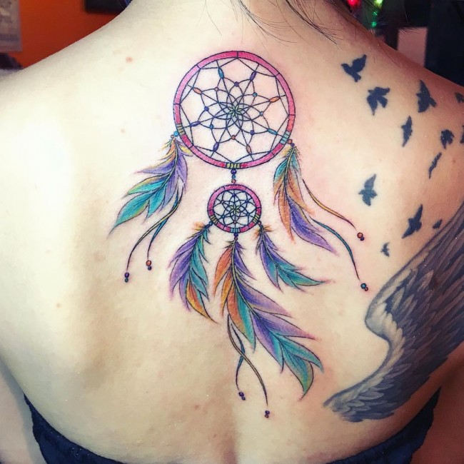 Dreamcatcher Tattoo In Red,Green,Blue,Orange Ink On Upper Back For Women