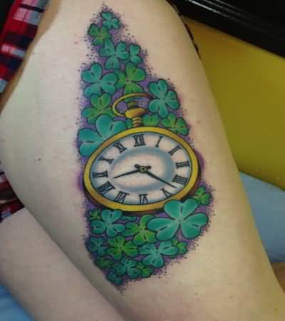 Green Shamrock Leaves And Clock Tattoo On Left Thigh For Girls