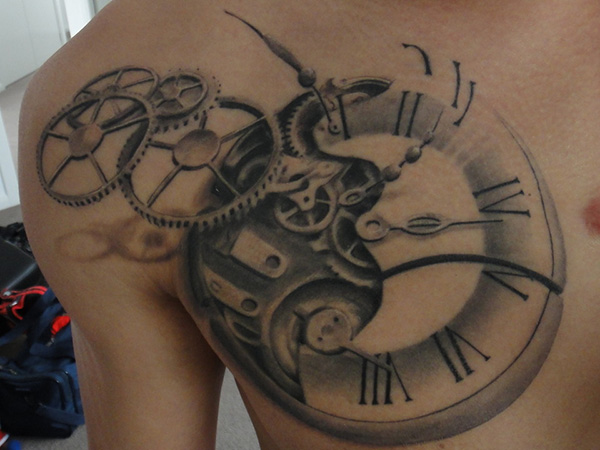 Grey And Black Clock Gears Tattoo On Front Shoulder