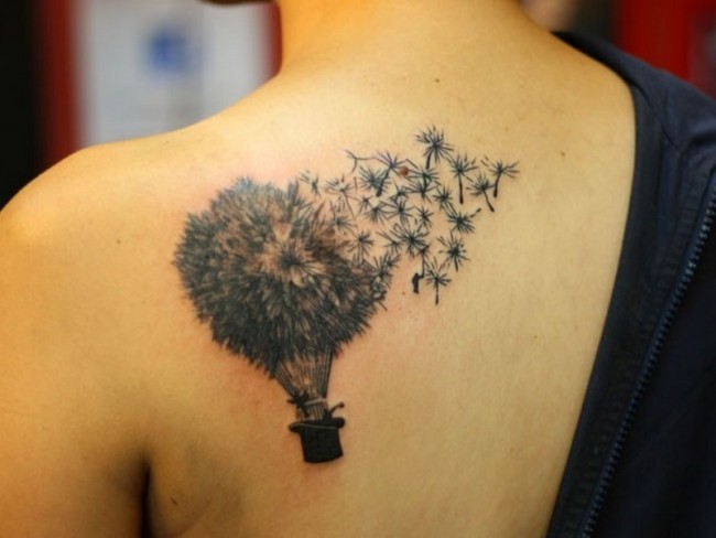 Hat Hanging With Blowing Dandelions Tattoo On Left Back Shoulder For Girl