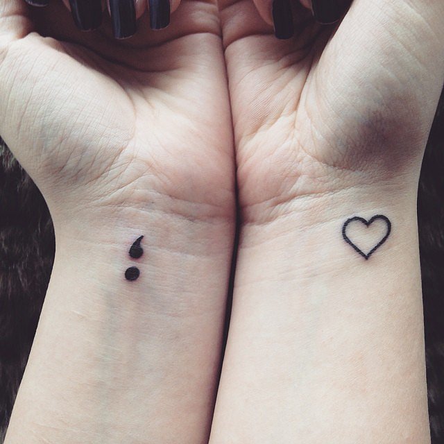 Outline Heart And Semicolon Tattoos On Girl Wrists