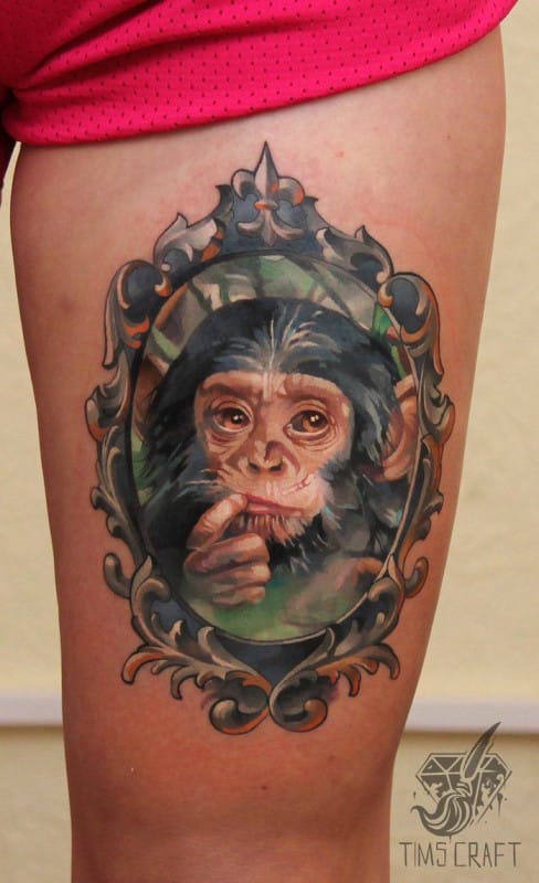 Sad Chimpanzee Face In Mirror Frame Tattoo