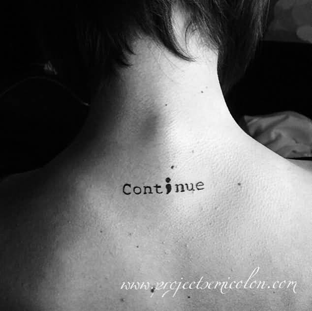Semicolon In Continue Word Tattoo On Upper Back