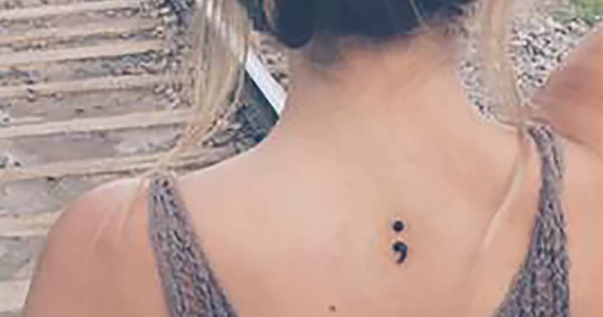Semicolon Tattoo On Girl Upper Back
