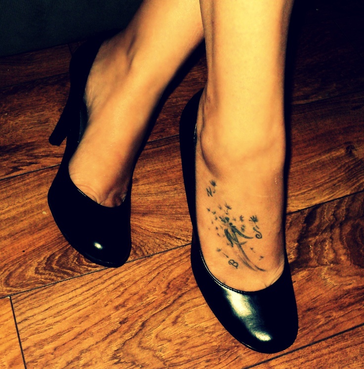 Small Dandelion Puff In Black Ink Tattoo On Foot
