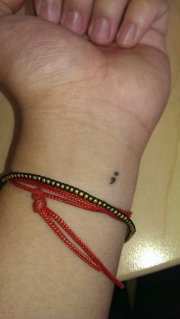 Tiny Semicolon Tattoo On Wrist