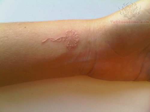 White Ink Dandelion Puff With Infinity Symbol Tattoo On Wrist