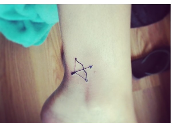 A Tiny Bow With Arrow Tattoo On Ankle