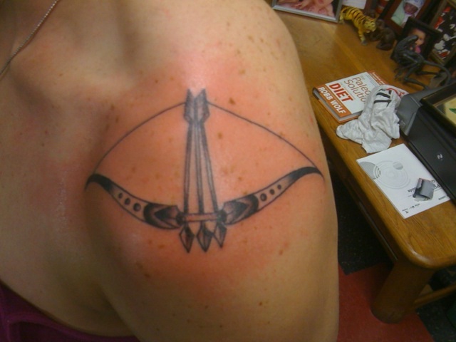 Adorable Bow And Arrow Tattoo On Left Shoulder