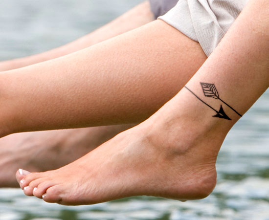 Arrow In Rubber Band Shape Tattoo On Ankle