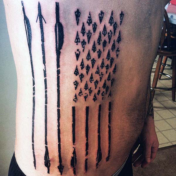 Arrows In American Flag Shape Tattoo On Rib