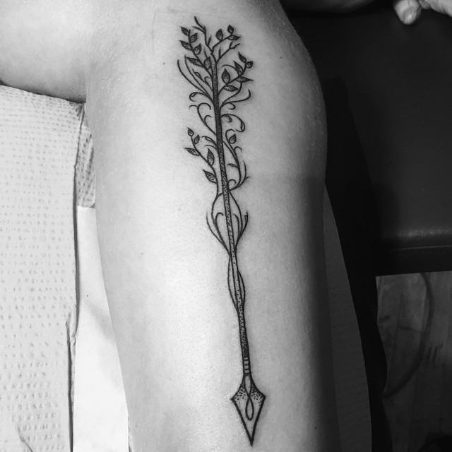 Awesome Arrow With Leaves Tattoo Design