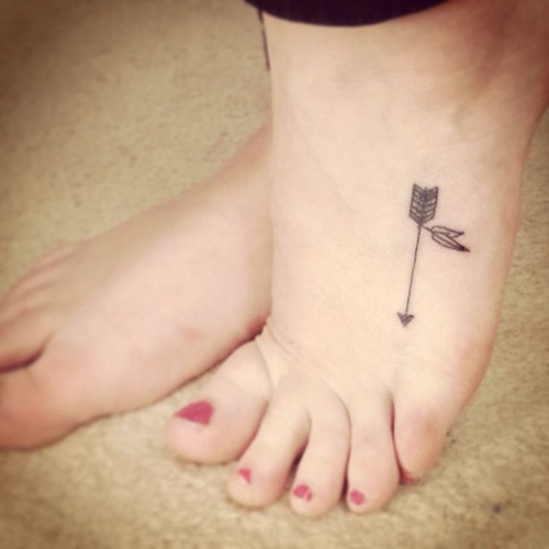 Awesome Black Arrow With Leaves Tattoo On Foot