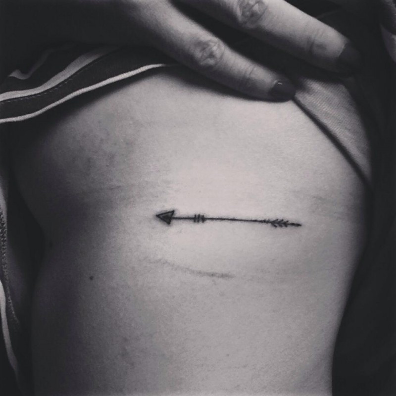 Beautifuly Made Tiny Arrow Tattoo On Rib