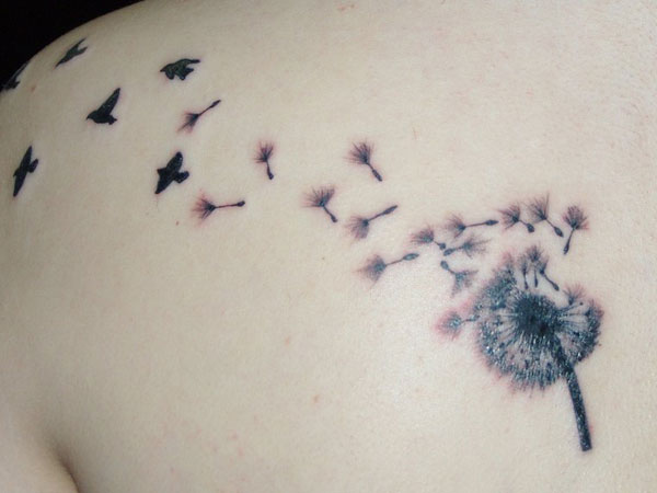 Birds Flying From Dandelion In Grey And Black Ink Tattoo On Left Shoulder