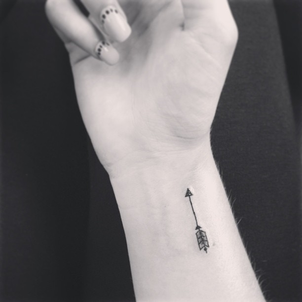 Black And White Small Arrow Tattoo On Wrist