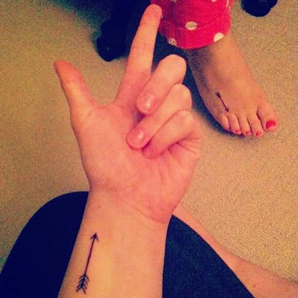 Black Colored Arrow Tattoo On Wrist For Girls