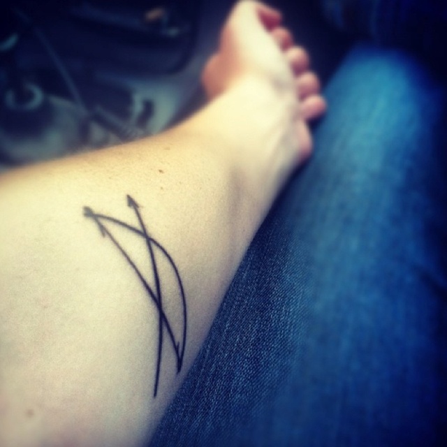 Black Ink Bow And Arrow Tattoo On Arm