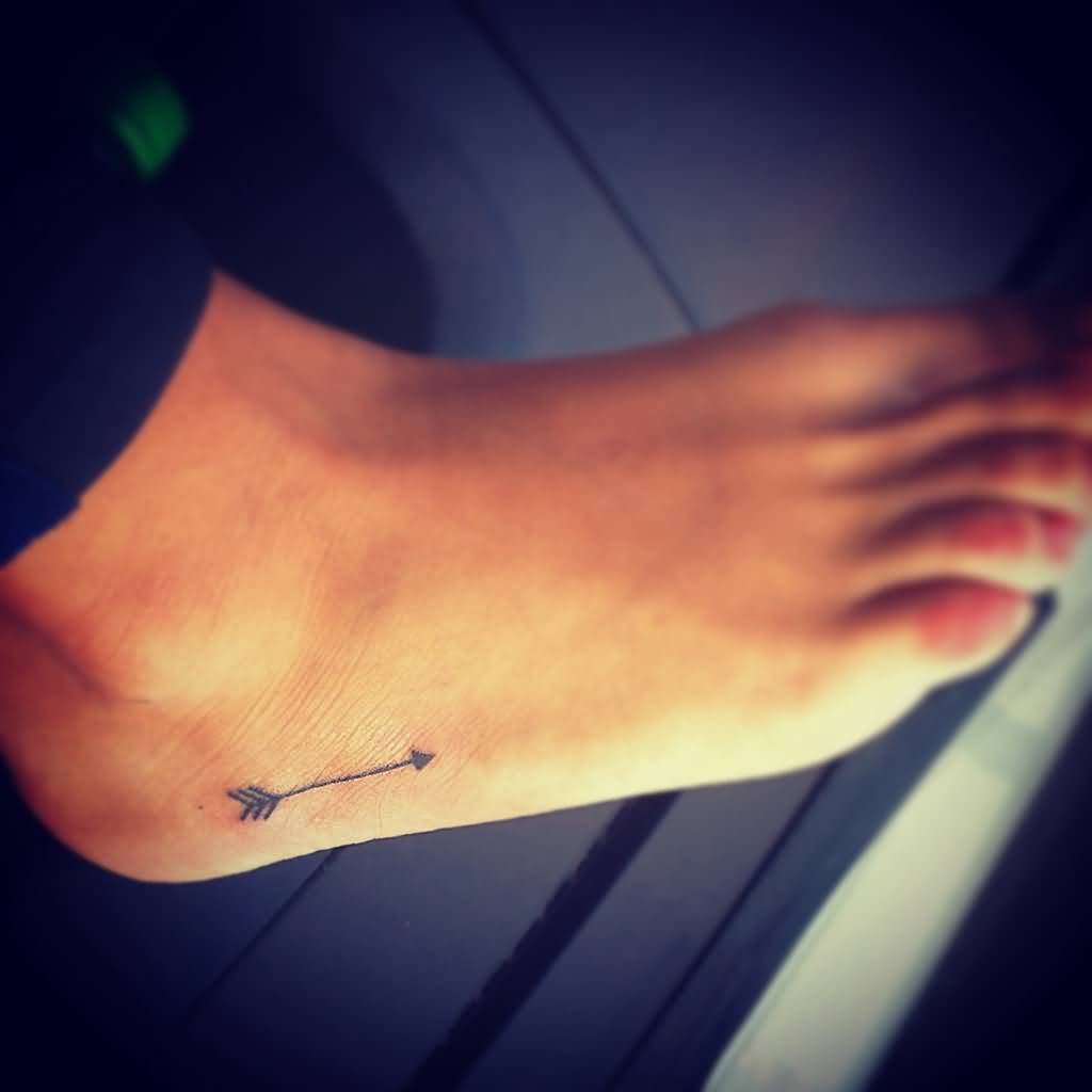 Black Ink Tiny Arrow Tattoo On Foot