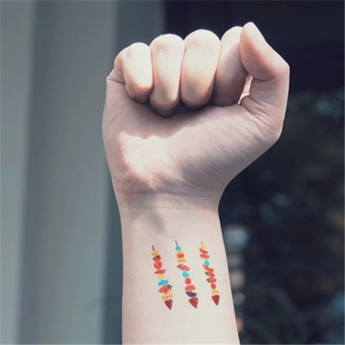 Colorful Fruits In Three Arrows Tattoo On Wrist