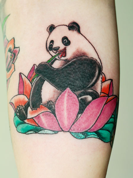 Colorful Panda Eating Bamboo Tattoo On Forearm