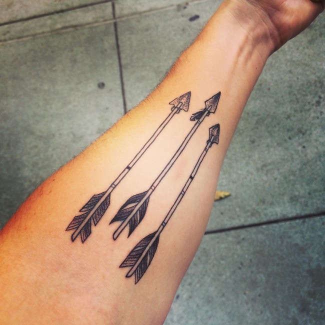 Cute Arrows Tattoo In Light Black Color On Arm