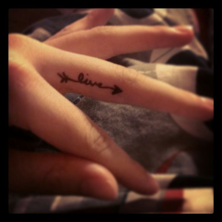 Cute Black Arrow With Live Tattoo On Finger