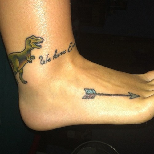 Dinosaur And Arrow Tattoo On Foot