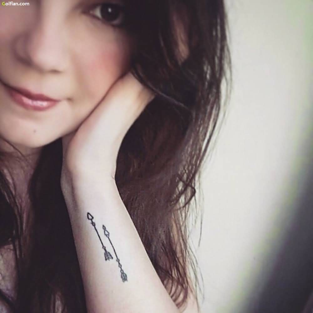 Impressive Two Arrows Tattoo On Wrist For Girl