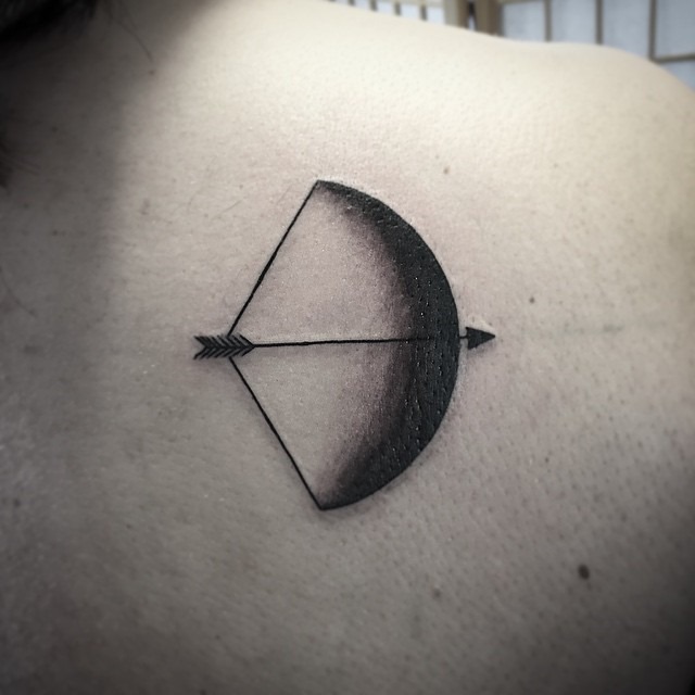 Incredible Black And Grey Bow And Arrow Tattoo On Upper Back