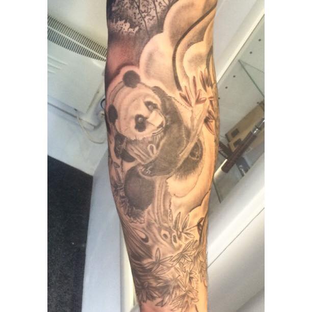 Incredible Panda With Tree And Leaves Tattoo On Sleeve