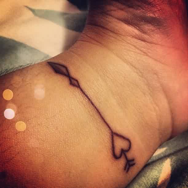 Innovative Black Inked Arrow Tattoo On Wrist