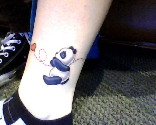Lovely Panda Looking At Heart Tattoo On Leg