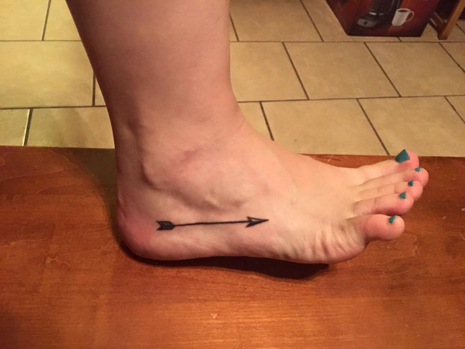 Nice Black Arrow Tattoo On Foot