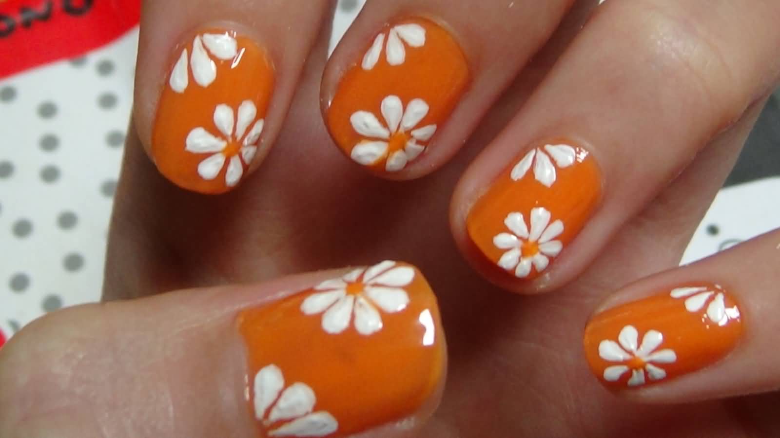 Orange Base Nails With White Acrylic Flowers Nail Art
