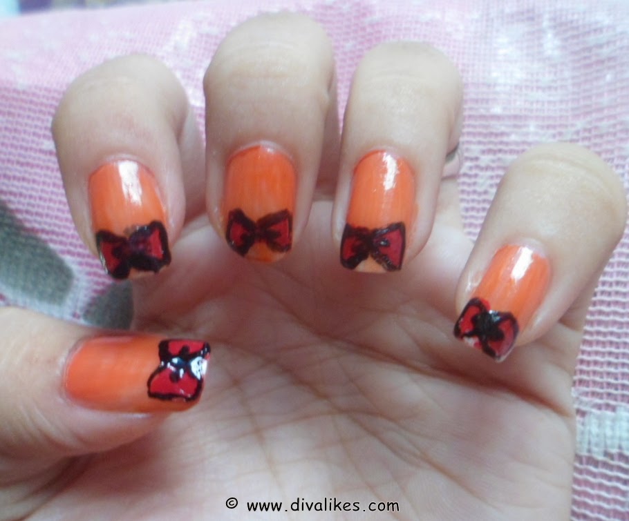 Orange Nails With Red Bow Nail Art