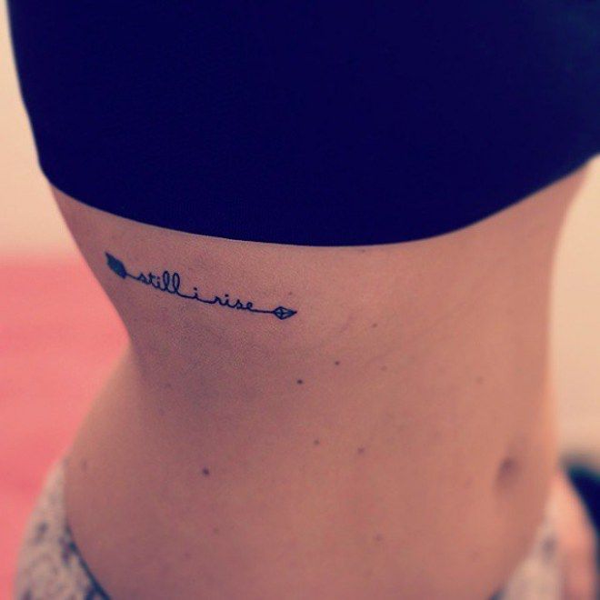 Outstanding Arrow With Still I Rise Words Tattoo On Rib For Girl