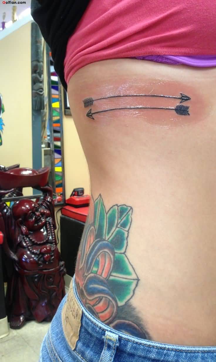 Perfectly Decorated Dual Arrow Tattoo On Rib